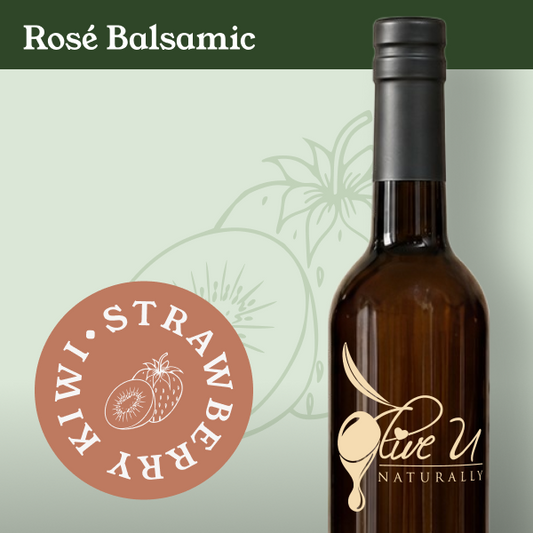 A dark amber glass bottle of rose balsamic with a black cap and a gold 'Love U Naturally' logo, shown on a pale green background with a dark green header reading 'Rose Balsamic' and a circular fruit flavor badge.
